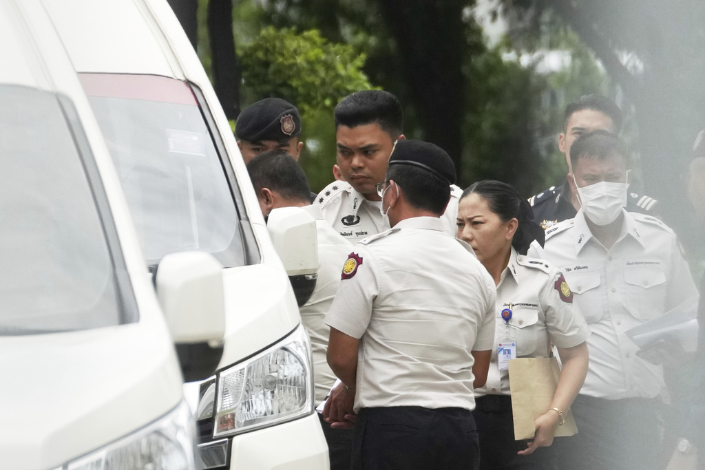 Thailand's former Prime Minister Thaksin Shinawatra, partly seen at left, leaves the Supreme Court for Bangkok Remand Prison in Bangkok, Thailand, Tuesday, Sept. 9, 2025, (AP Photo/Sakchai Lallit)