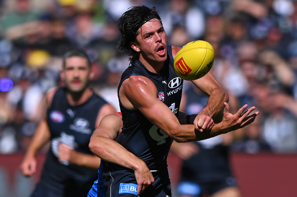 Elijah Hollands of Carlton passes the ball during their Australian Football League against the Melbourne Demons in Melbourne, Australia, March 29, 2026. (James Ross/AAP Image via AP)