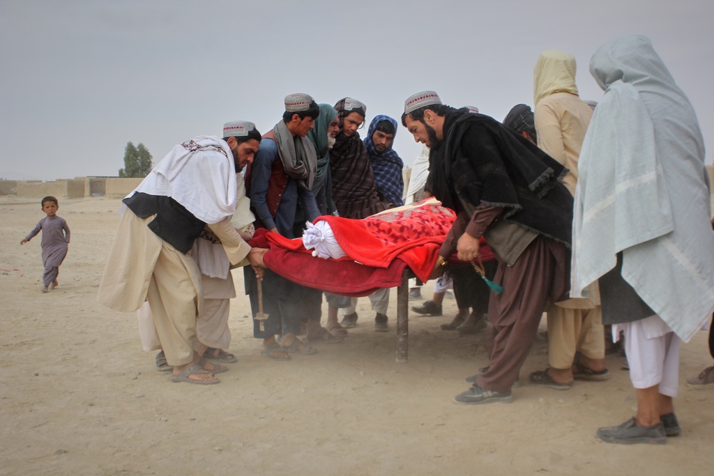 Afghans prepare the body of a man killed during an overnight exchange of fire between Afghan and Pakistani forces along the border in Spin Boldak, Kandahar province, Afghanistan, Saturday, Dec. 6, 2025. (AP Photo/Sibghatullah)