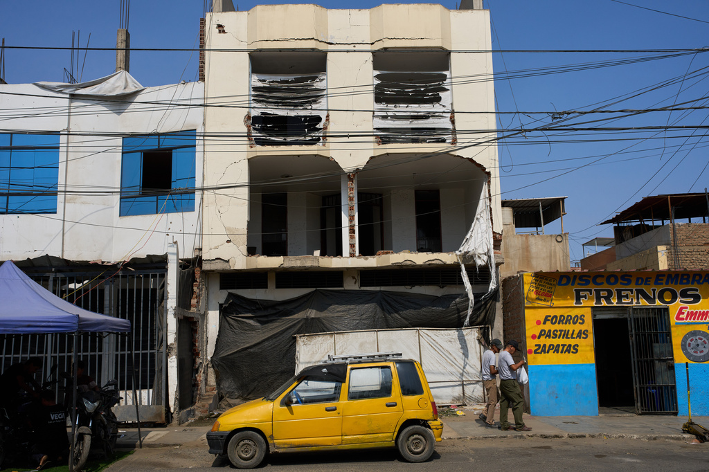 A building damaged in an explosives attack that police say was linked to extortion stands in Trujillo, Peru, Monday, May 18, 2026. (AP Photo/Rodrigo Abd)