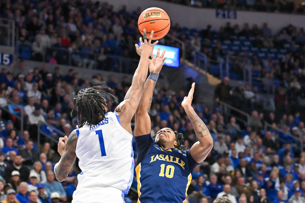 La Salle Guard Jaden Johnson (10) shoots over Saint Louis' Quentin Jones (1) during the first half of an NCAA college basketball game Saturday, Feb. 7, 2026, in St. Louis. (AP Photo/Ali Overstreet)