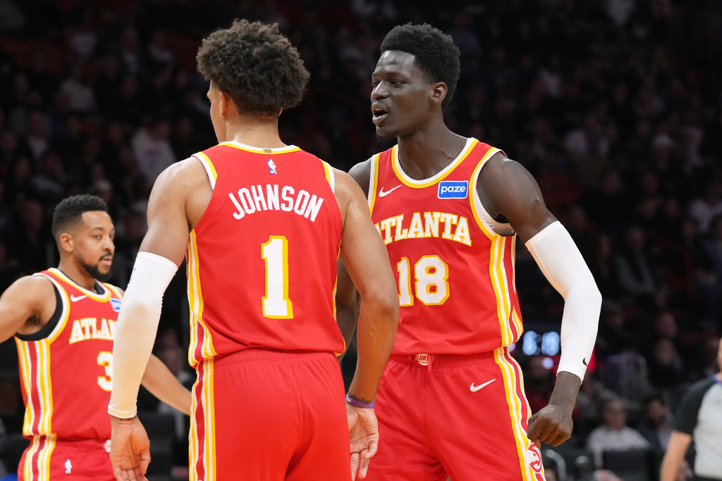 Atlanta Hawks forward Jalen Johnson (1) celebrates with Mouhamed Gueye (18) after dunking the ball during the first half of an NBA basketball game against the Miami Heat Tuesday, Feb. 3, 2026, in Miami. (AP Photo/Marta Lavandier)