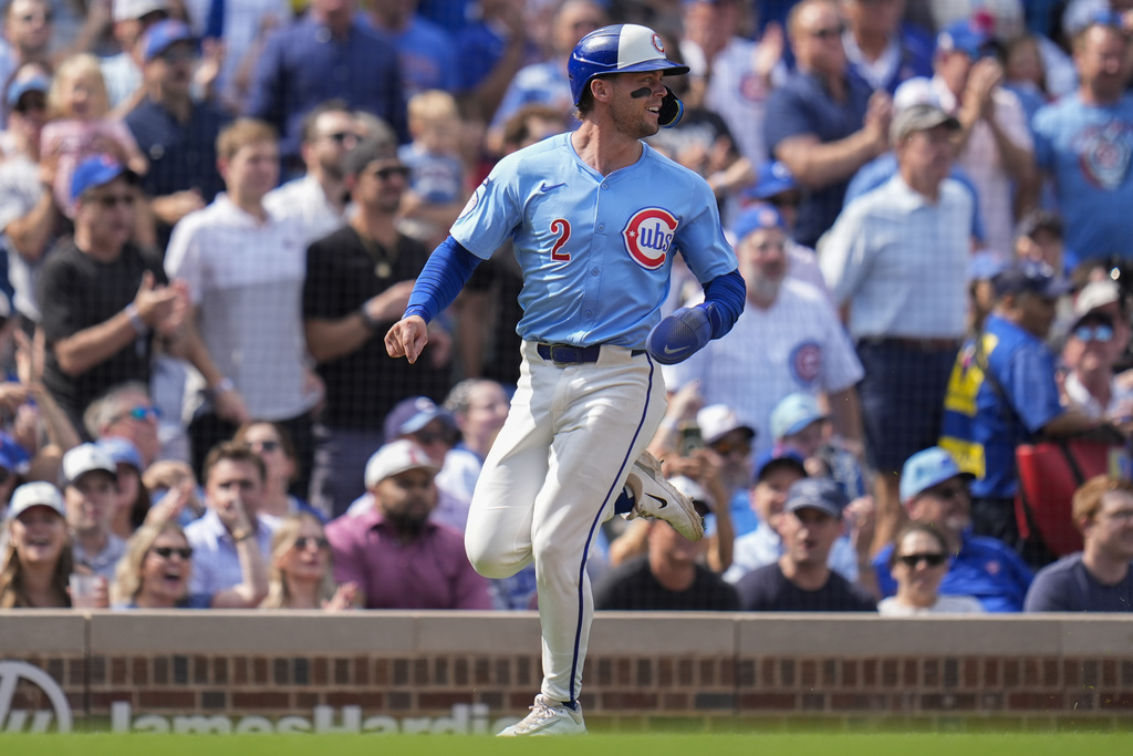 Chicago Cubs' Nico Hoerner (2) scores on a triple by designated hitter Moisés Ballesteros during the third inning of a baseball game against the Tampa Bay Rays, Friday, Sept. 12, 2025, in Chicago. (AP Photo/Erin Hooley)