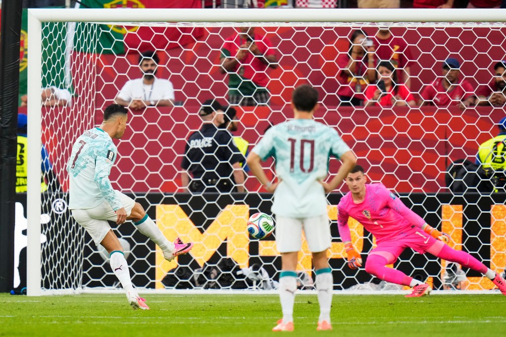 Portugal's Cristiano Ronaldo (7) scores on a penalty kick past Croatia goalkeeper Dominik Livakovic (1) during the World Cup round of 32 soccer match between Portugal and Croatia in Toronto, Thursday, July 2, 2026. (Chris Young/The Canadian Press via AP)