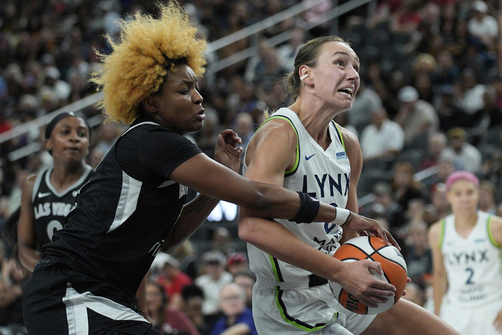 Las Vegas Aces forward NaLyssa Smith (3) tries to steal the ball from Minnesota Lynx forward Alanna Smith (8) during the second half of a WNBA basketball game Thursday, Sept. 4, 2025, in Las Vegas. (AP Photo/John Locher)
