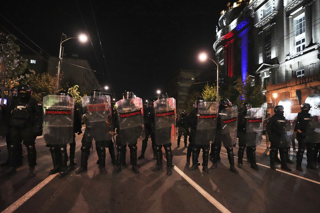 Serbian gendarmerie officers guard a street during an anti-government protest near the Serbian Progressive Party office in Belgrade, Serbia, Friday, Aug. 15, 2025. (AP Photo/Darko Vojinovic)