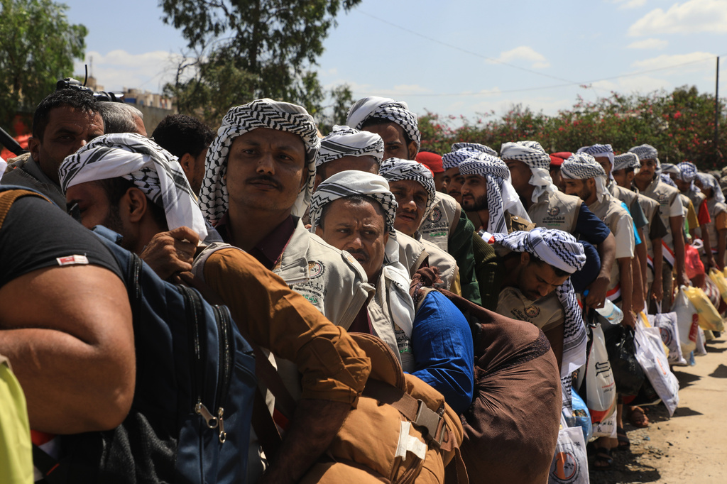 Houthi prisoners freed in Mokha carry their belongings as they arrive in Sanaa, Yemen, Saturday, Sept. 12, 2026, following the Houthi takeover of the southern Red Sea port city. (AP Photo)