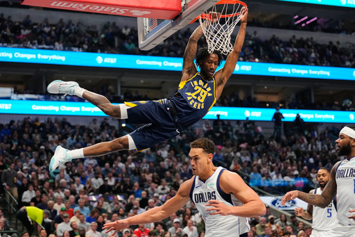 Indiana Pacers guard Quenton Jackson (29) follows through on a dunk over Dallas Mavericks' Dwight Powell (7) and Jaden Hardy, right, in the first half of an NBA basketball game Wednesday, Oct. 29, 2025, in Dallas. (AP Photo/Tony Gutierrez) Indiana Pacers guard Quenton Jackson (29) follows through on a dunk over Dallas Mavericks' Dwight Powell (7) and Jaden Hardy, right, in the first half of an NBA basketball game Wednesday, Oct. 29, 2025, in Dallas. (AP Photo/Tony Gutierrez)