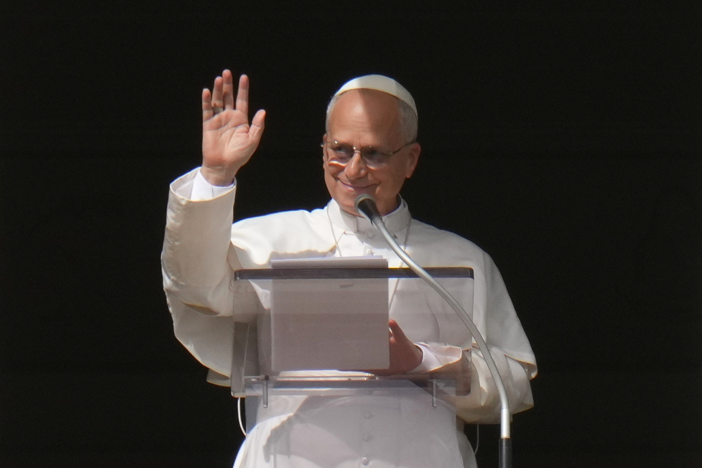 Pope Leo XIV delivers his blessing as he recites the Angelus noon prayer from the window of his studio overlooking St.Peter's Square, at the Vatican, Sunday, Oct. 26, 2025. (AP Photo/Alessandra Tarantino)