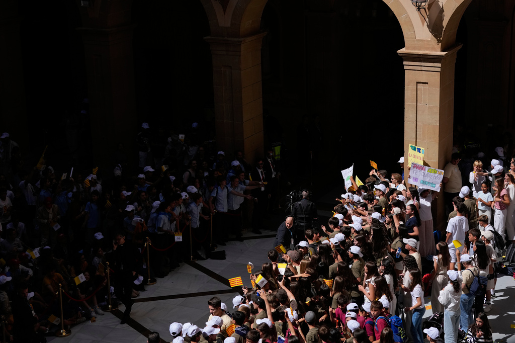 People wait for the arrival of Pope Leo XIV to lead a rosary at the Abbey of Our Lady of Montserrat, in Montserrat, Spain, Wednesday, June 10, 2026. (AP Photo/Alessandra Tarantino)
