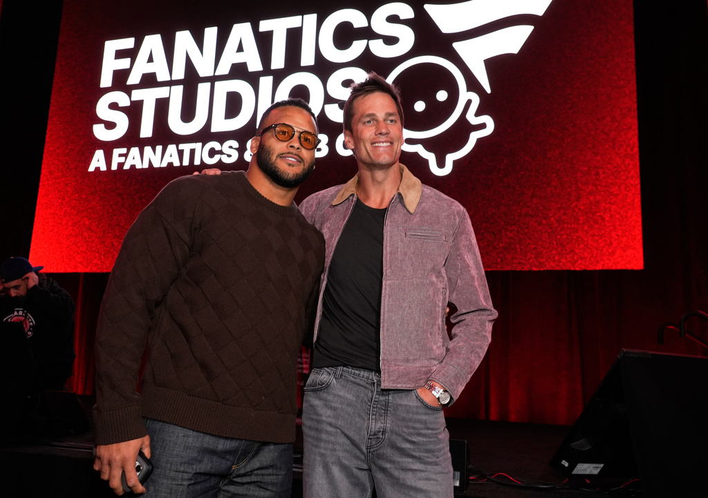 Retired NFL players Aaron Donald, left, and Tom Brady pose together at the launch party for Fanatics Studio, a global studio for sports entertainment, on Tuesday, Jan. 13, 2026, at the Intuit Dome in Inglewood, Calif. (AP Photo/Chris Pizzello)