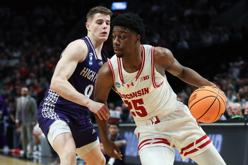 Wisconsin guard John Blackwell (25) drives the ball past High Point guard Conrad Martinez during the second half in the first round of the NCAA college basketball tournament Thursday, March 19, 2026, in Portland, Ore. (AP Photo/Amanda Loman)