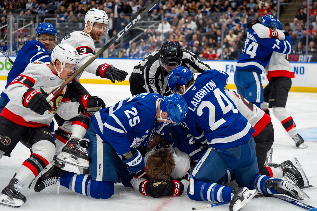 The Toronto Maple Leafs and the Ottawa Senators brawl on the ice during third-period NHL hockey game action in Toronto, Saturday, Feb 28, 2026. (Frank Gunn/The Canadian Press via AP)
