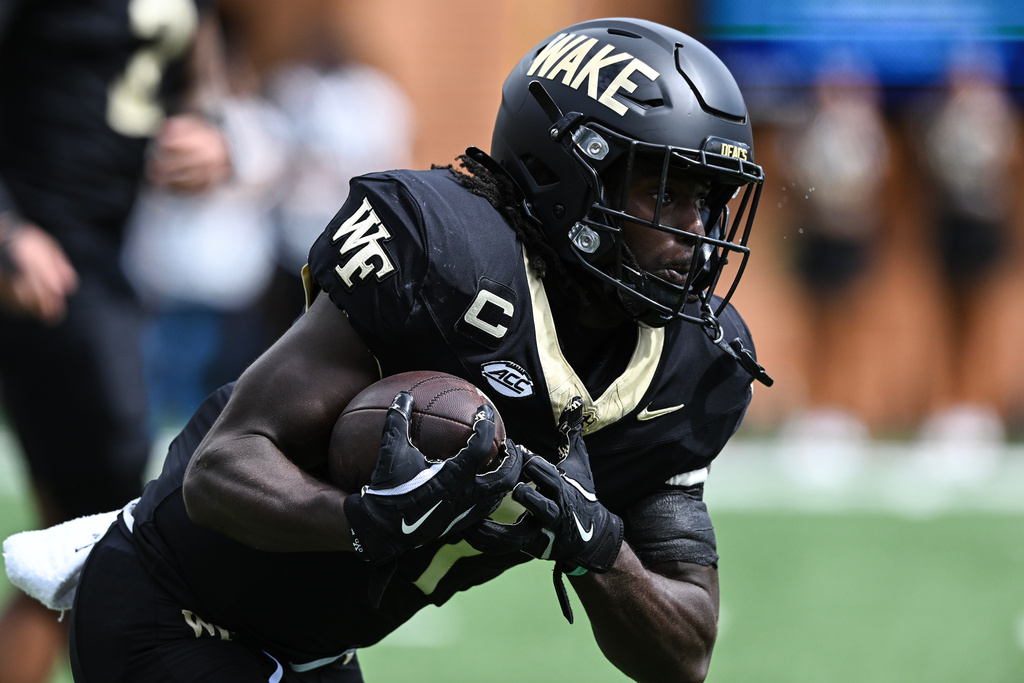 Wake Forest running back Demond Claiborne (1) carries the ball during the first half of an NCAA college football game against Georgia Tech, Saturday, Sept. 27, 2025, in Winston-Salem, N.C. (AP Photo/Matt Kelley)