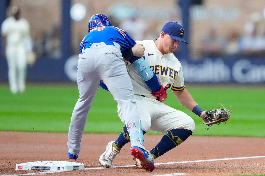 Chicago Cubs' Pete Crow-Armstrong, left, runs into Milwaukee Brewers first baseman Andrew Vaughn, right, after grounding out during the first inning of a baseball game Monday, Sept. 7, 2026, in Milwaukee. (AP Photo/Kayla Wolf)