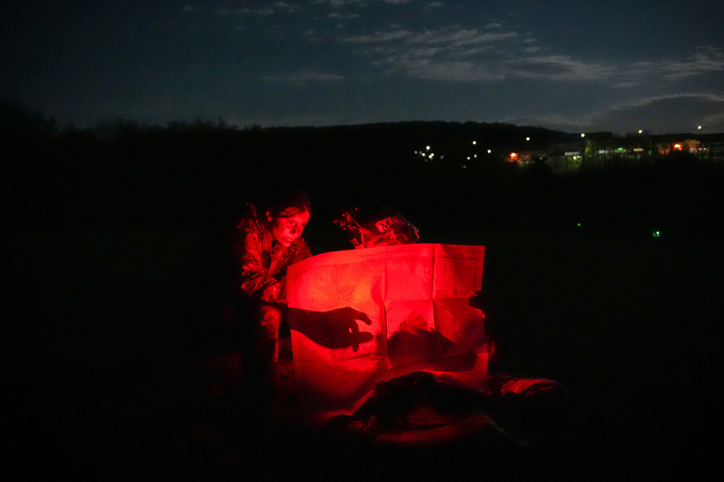 Cadets plot points on a map before competing in night land navigation during the Sandhurst Military Skills Competition at the United States Military Academy in West Point, N.Y., Friday, May 1, 2026. (AP Photo/Julia Demaree Nikhinson)
