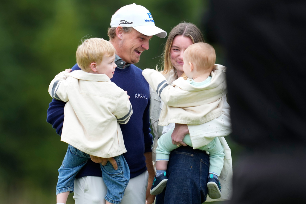 Bud Cauley, top left, of the United States, celebrates with his family on the 18th green after winning the Canadian Open golf tournament in Caledon, Ontario, Sunday June 14, 2026. (Frank Gunn/The Canadian Press via AP)