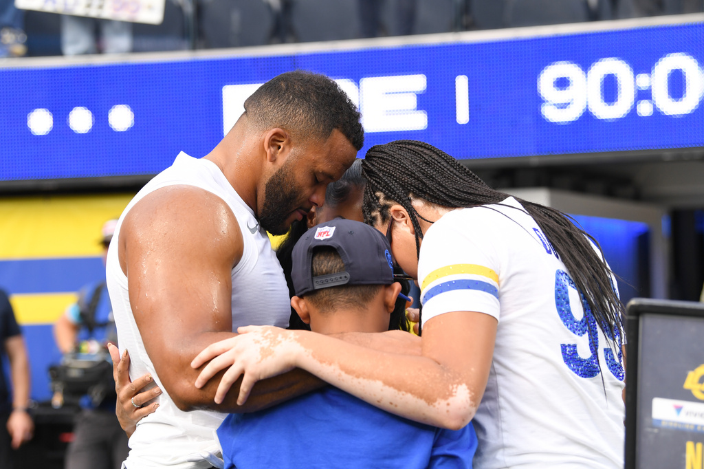 Los Angeles Rams defensive end Aaron Donald huddles with his family before an NFL football game against the New York Giants in Inglewood, Calif., Monday, Sept. 21, 2026. (AP Photo/Katie Chin)