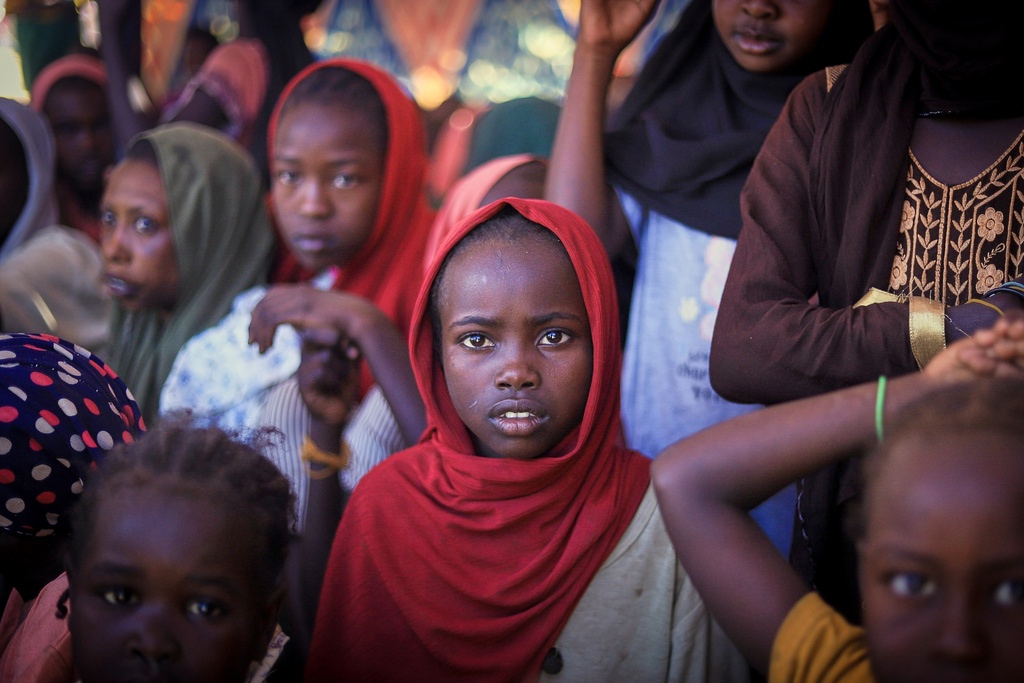 This photo released by The Norwegian Refugee Council (NRC), shows displaced women and children from el-Fasher at a camp where they sought refuge from fighting between government forces and the RSF, in Tawila, Darfur region, Sudan, Monday, Nov. 3, 2025. (NRC via AP)