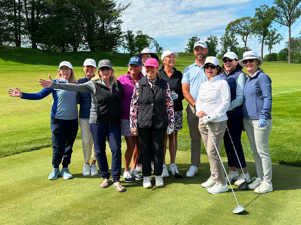 Braden Shattuck, a club professional who qualified to play in this weekend's PGA Championship at Aronimink Golf Club, poses with golfers during a women's clinic at Rolling Green Golf Club, Wednesday, May 13, 2026, in Springfield, Pa. (AP Photo/Dan Gelston)