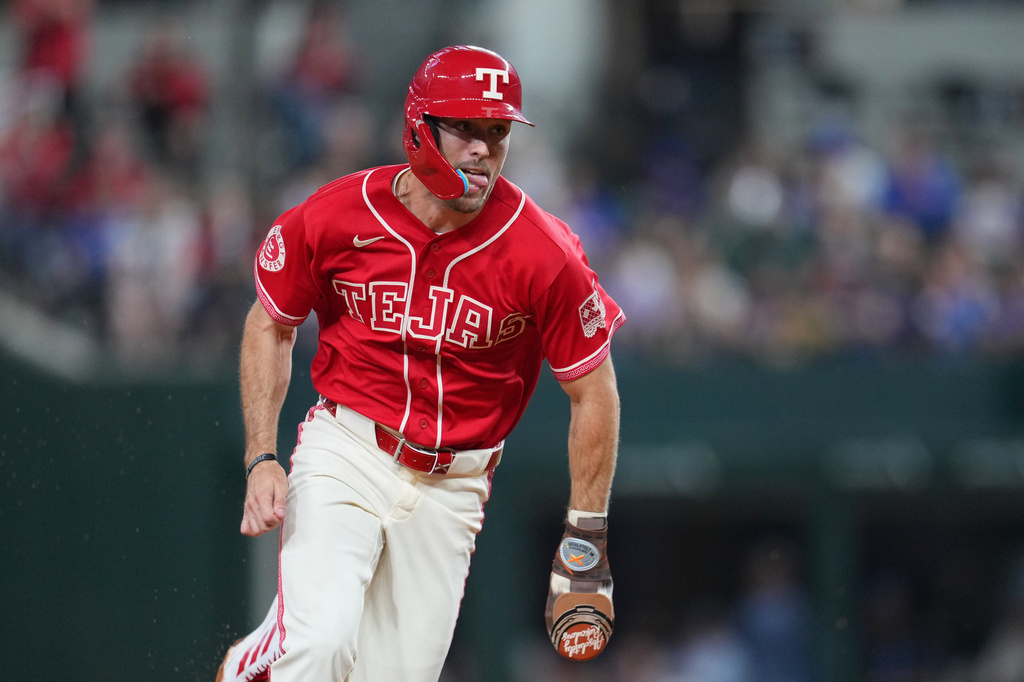 Texas Rangers' Evan Carter runs the bases while scoring from second base on a pinch hit by teammate Justin Foscue during the fifth inning of a baseball game against the Chicago Cubs, Friday, May 8, 2026, in Arlington, Texas. (AP Photo/Julio Cortez)