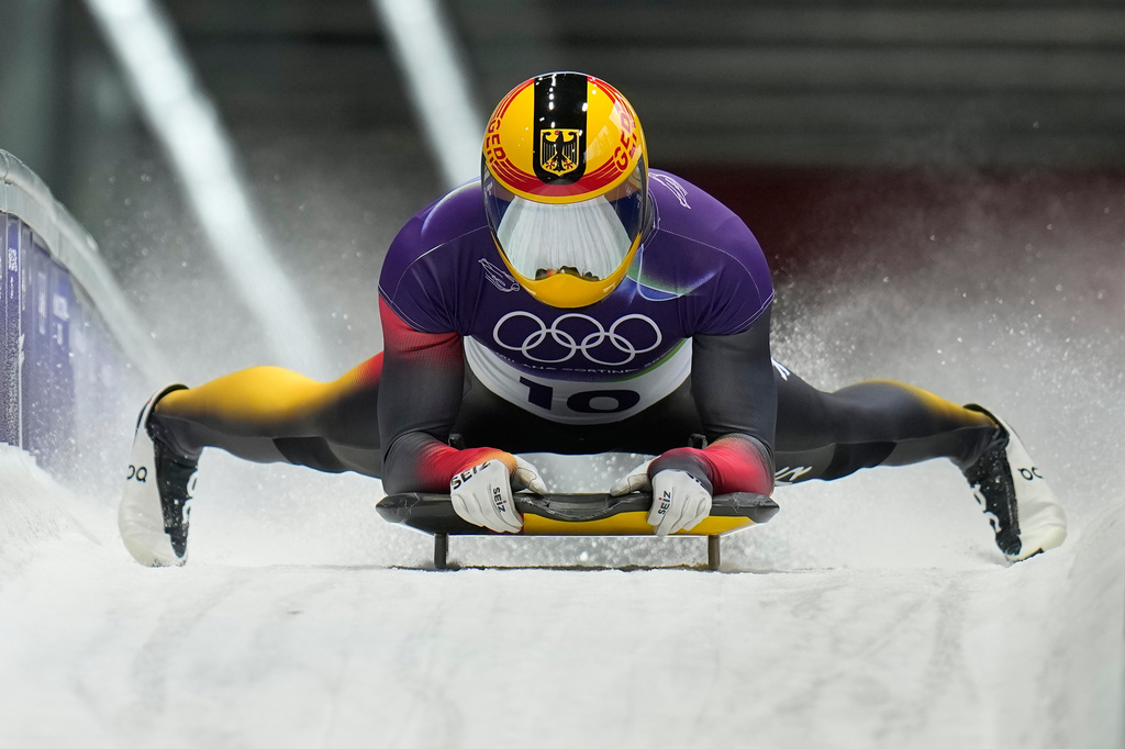 Germany's Axel Jungk arrives at the finish during a men's skeleton run at the 2026 Winter Olympics, in Cortina d'Ampezzo, Italy, Thursday, Feb. 12, 2026. (AP Photo/Alessandra Tarantino)