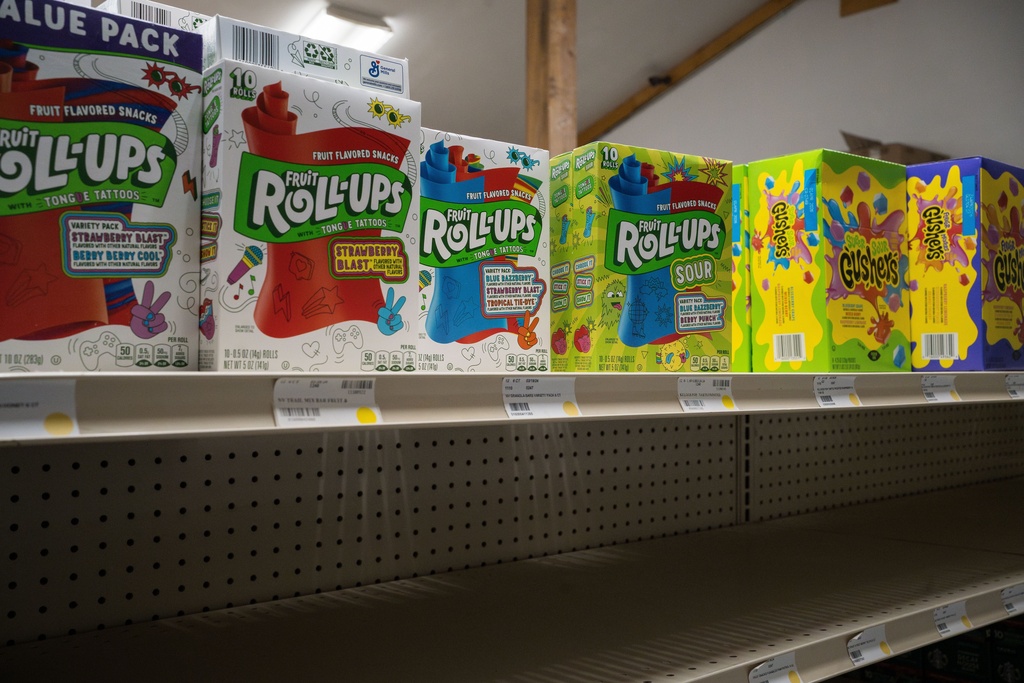 Fruit Roll-Ups and Gushers sit on a shelf of a grocery store above an empty shelf in Ambler, Alaska, Wednesday, Oct. 1, 2025. (AP Photo/Annika Hammerschlag)