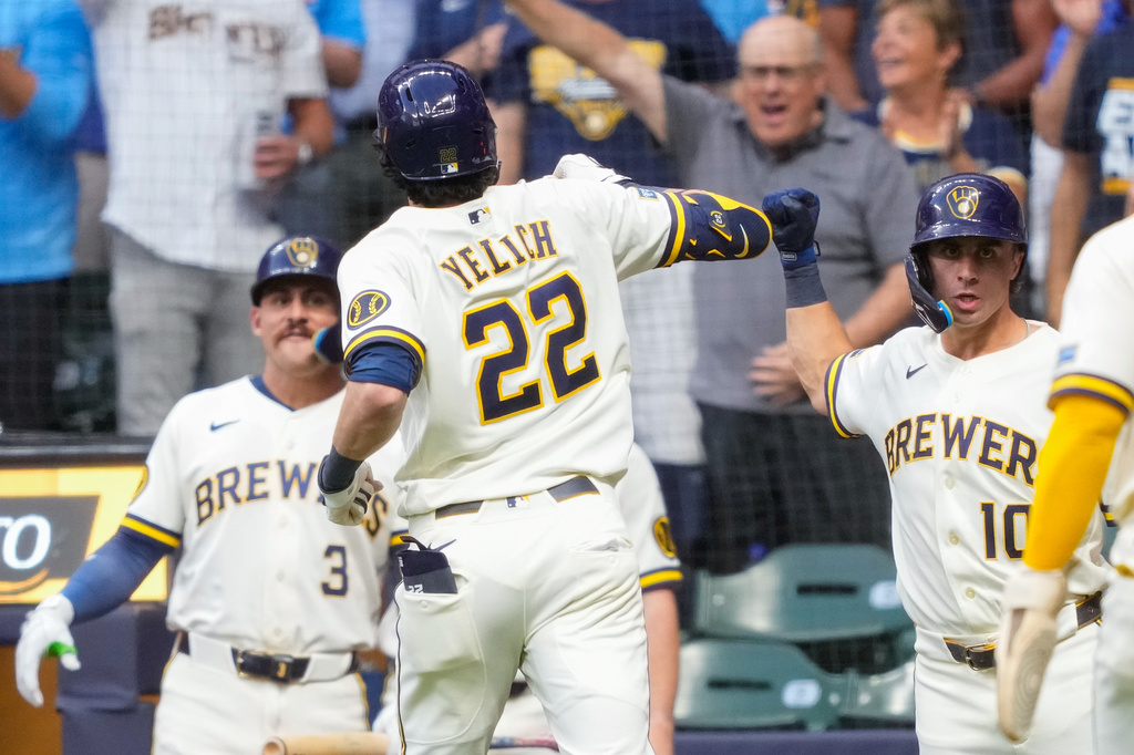 Milwaukee Brewers' Sal Frelick, right, reacts to a three-run home run hit by Milwaukee Brewers designated hitter Christian Yelich (22) during the first inning of a baseball game against the Chicago Cubs Wednesday, Sept. 9, 2026, in Milwaukee. (AP Photo/Kayla Wolf)