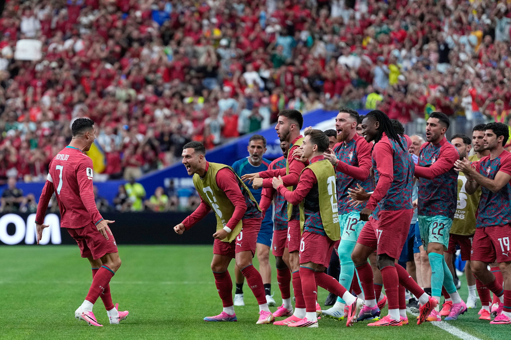 Portugal's Cristiano Ronaldo, left, celebrates after scoring the opening goal during the World Cup Group K soccer match between Portugal and Uzbekistan in Houston, Tuesday, June 23, 2026. (AP Photo/Ashley Landis)