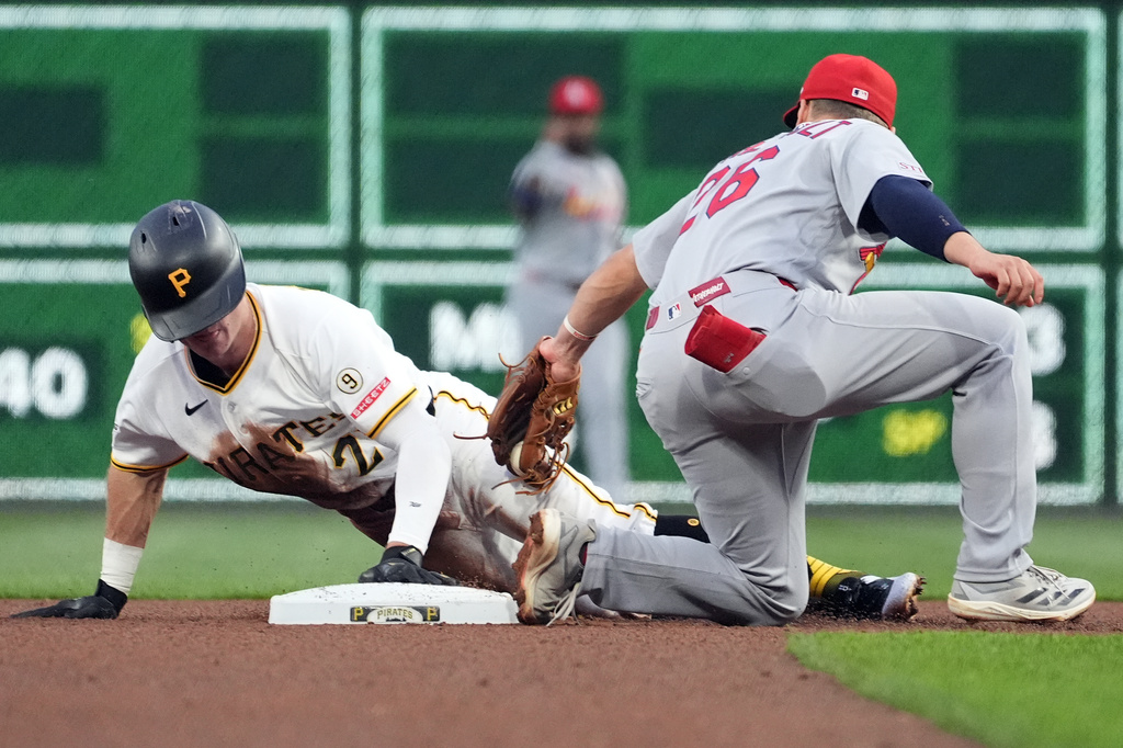 Pittsburgh Pirates' Jake Mangum, left, slides under a tag by St. Louis Cardinals second baseman JJ Wetherholt, right, for a stolen base in the fourth inning of a baseball game in Pittsburgh, Monday, April 27, 2026. (AP Photo/Tom E. Puskar)