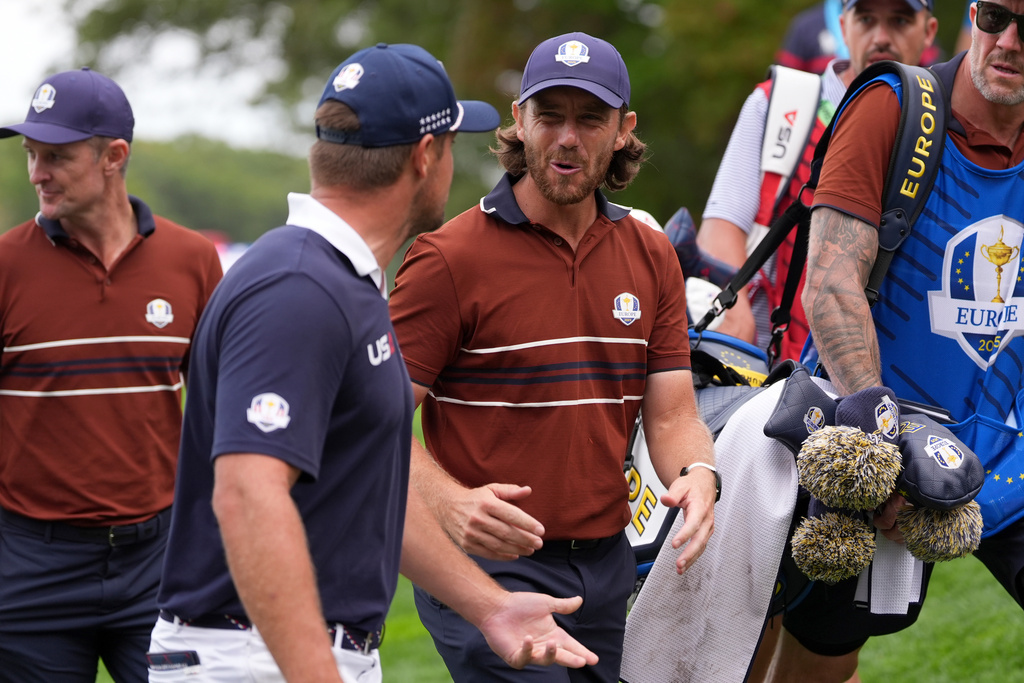 United States' Bryson DeChambeau and Europe's Tommy Fleetwood talk on the way to the on the 16th tee at Bethpage Black golf course during the Ryder Cup golf tournament, Saturday, Sept. 27, 2025, in Farmingdale, N.Y. (AP Photo/Lindsey Wasson)