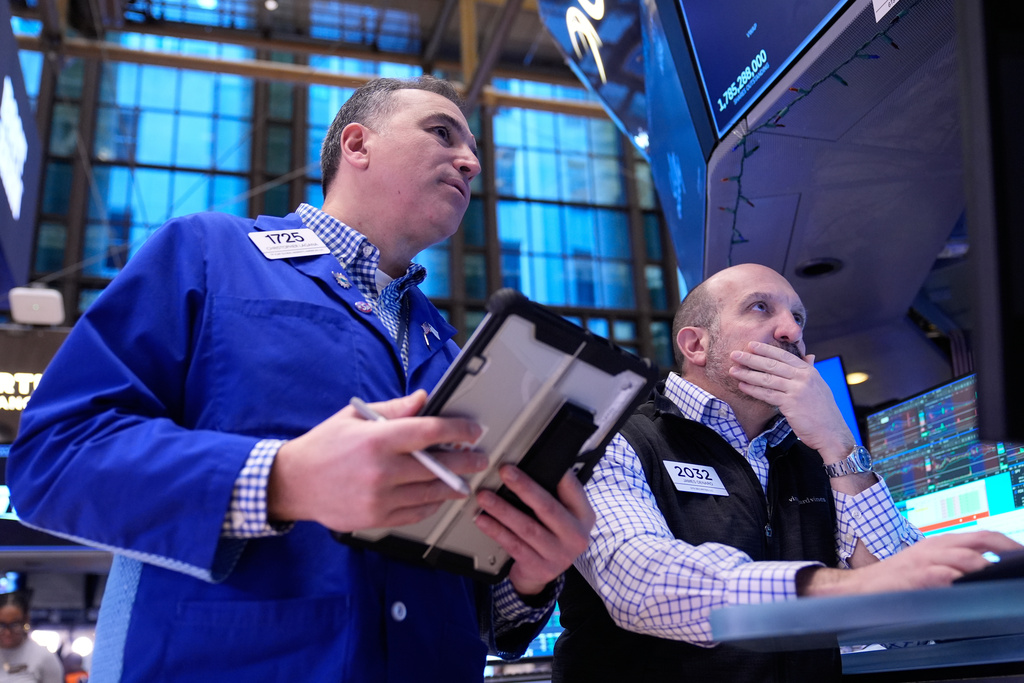 Christopher Lagana and James Denaro work on the floor at the New York Stock Exchange in New York, Friday, Jan. 9, 2026. (AP Photo/Seth Wenig)