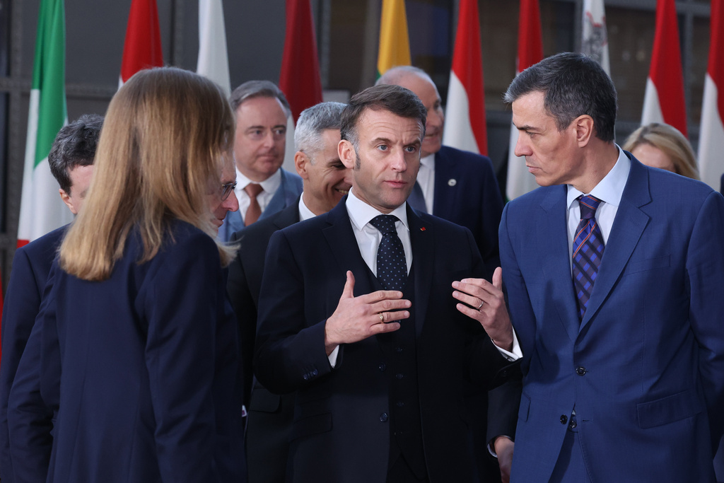 French President Emmanuel Macron, center, speaks with Spain's Prime Minister Pedro Sanchez, right, prior to a group photo at the EU summit in Brussels, Thursday, March 19, 2026. (AP Photo/Omar Havana)