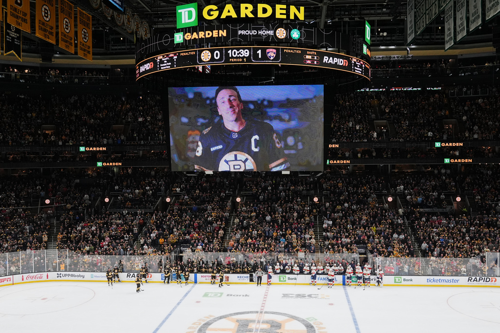 Florida Panthers left wing Brad Marchand (63), who played for more than 15 seasons with the Boston Bruins, is honored with a standing ovation during a break in the first period of an NHL hockey game, Tuesday, Oct. 21, 2025, in Boston. (AP Photo/Charles Krupa)