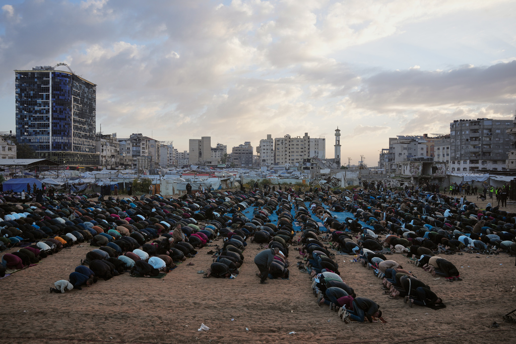 Palestinians offer Eid al-Fitr prayers in Gaza City, Friday, March 20, 2026. (AP Photo/Abdel Kareem Hana)