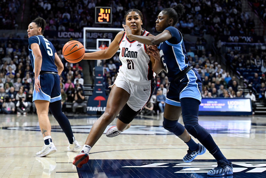 UConn forward Sarah Strong (21) drives to the basket as Villanova forward Denae Carter defends in the first half of an NCAA college basketball game, Thursday, Jan. 15, 2026, in Storrs, Conn. (AP Photo/Jessica Hill)