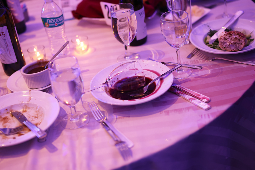 An abandoned wine glass sits in a bowl after an incident occurred at the White House Correspondents Dinner at the Washington Hilton, Saturday, April 25, 2026, in Washington. (AP Photo/Tom Brenner)