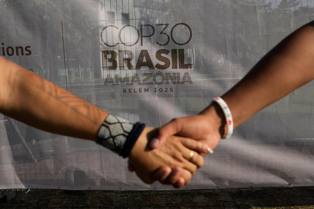 Indigenous people hold hands during a demonstration in defense of the Amazon during the COP30 U.N. Climate Summit, in Belem, Para state, Brazil, Thursday, Nov. 6, 2025. (AP Photo/Eraldo Peres)