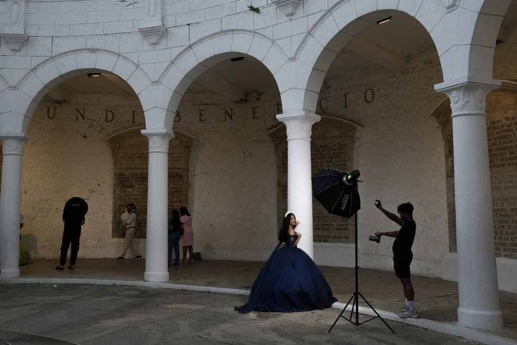 A young woman poses for photos inside a former bastion that was part of the colonial defenses against pirates in Casco Viejo, the historic district of Panama City, also a UNESCO World Heritage Site, Sunday, Aug. 10, 2025. (AP Photo/Matias Delacroix)
