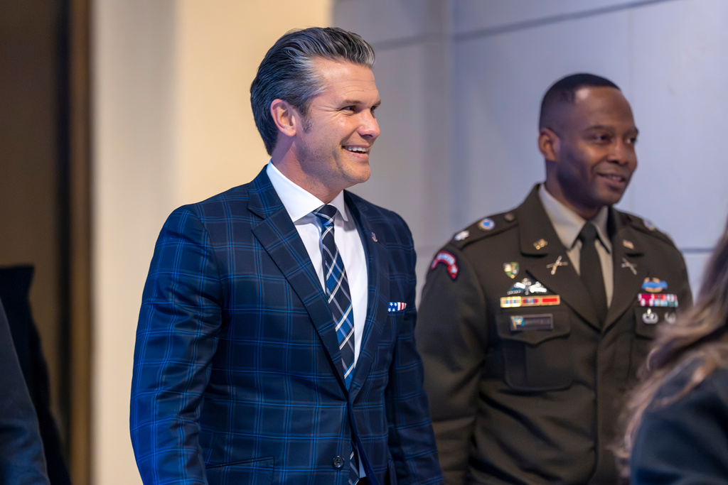 Defense Secretary Pete Hegseth smiles as he walks to a secure room in the basement of the Capitol to brief lawmakers on how he handled a military strike on a suspected drug smuggling boat and its crew in the Caribbean near Venezuela Sept. 2, at the Capitol in Washington, Tuesday, Dec. 9, 2025. (AP Photo/J. Scott Applewhite)