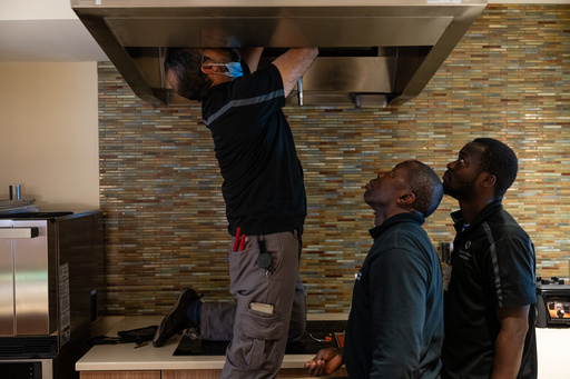 Maintenance workers Enaytullah Hafizi, left, originally from Afghanistan, Eric Frimpong, center, originally from Ghana, and Melvin Palmer, right, originally from Sierra Leone, fix an overhead light at Goodwin House Alexandria, Thursday, Oct. 16, 2025, in Alexandria, Va. (AP Photo/Eric Lee) Maintenance workers Enaytullah Hafizi, left, originally from Afghanistan, Eric Frimpong, center, originally from Ghana, and Melvin Palmer, right, originally from Sierra Leone, fix an overhead light at Goodwin House Alexandria, Thursday, Oct. 16, 2025, in Alexandria, Va. (AP Photo/Eric Lee)