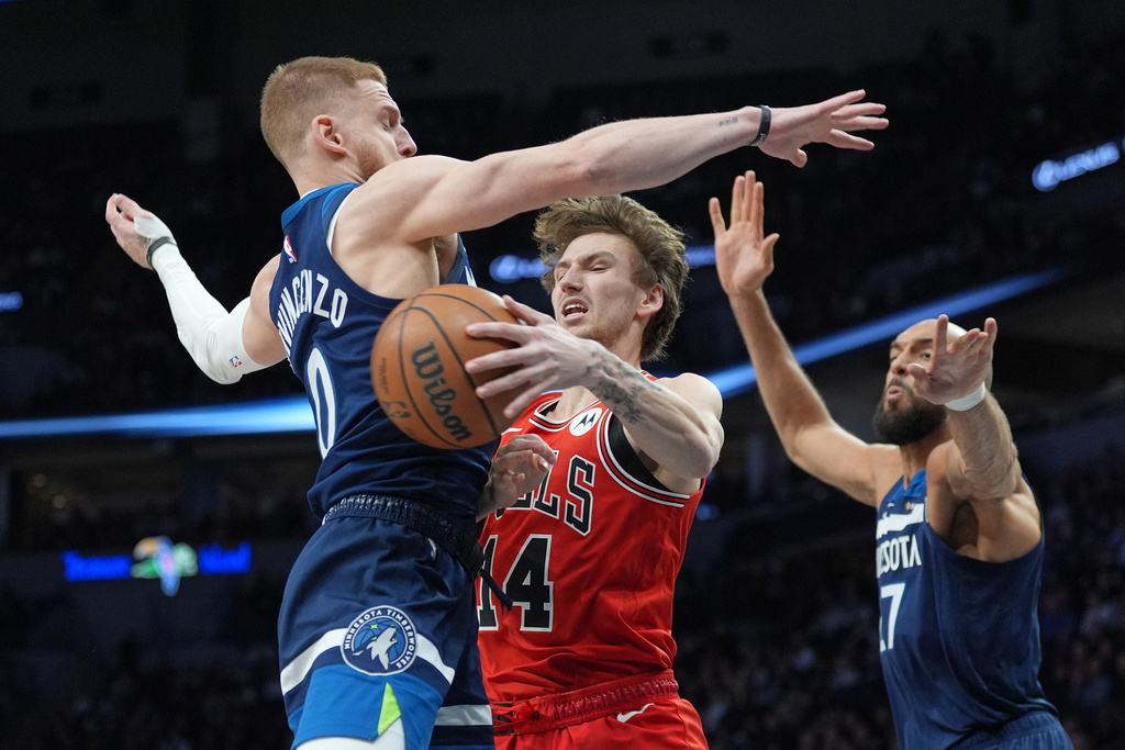 Chicago Bulls forward Matas Buzelis (14) looks to pass the ball against Minnesota Timberwolves guard Donte DiVincenzo (0) and center Rudy Gobert (27) during the first half of an NBA basketball game, Thursday, Jan. 22, 2026, in Minneapolis. (AP Photo/Abbie Parr)
