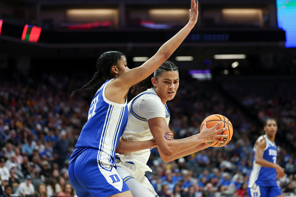 UCLA center Lauren Betts, right, battles in the paint with Duke center Arianna Roberson (21) during the first half in the Elite Eight of the NCAA college basketball tournament, Sunday, March 29, 2026, in Sacramento, Calif. (AP Photo/Sara Nevis)