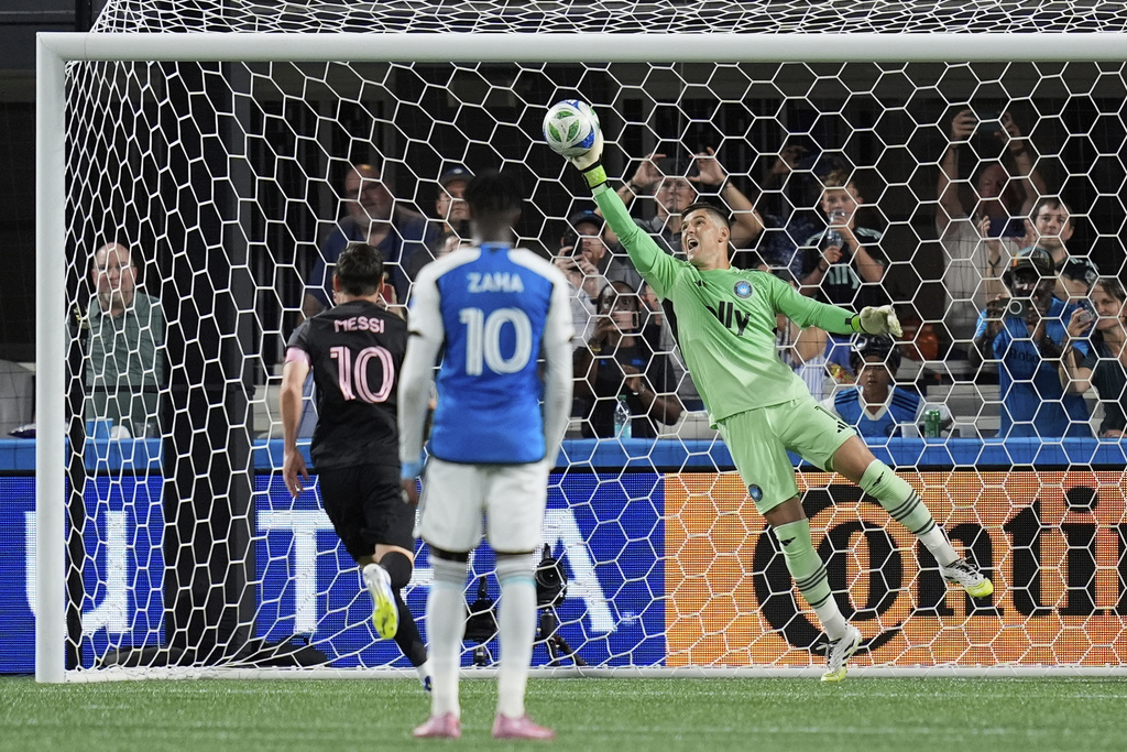 Charlotte FC goalkeeper Kristijan Kahlina (1) stops a penalty shot from Inter Miami forward Lionel Messi, left, during the first half of an MLS soccer match, Saturday, Sept. 13, 2025, in Charlotte, N.C. (AP Photo/Erik Verduzco)