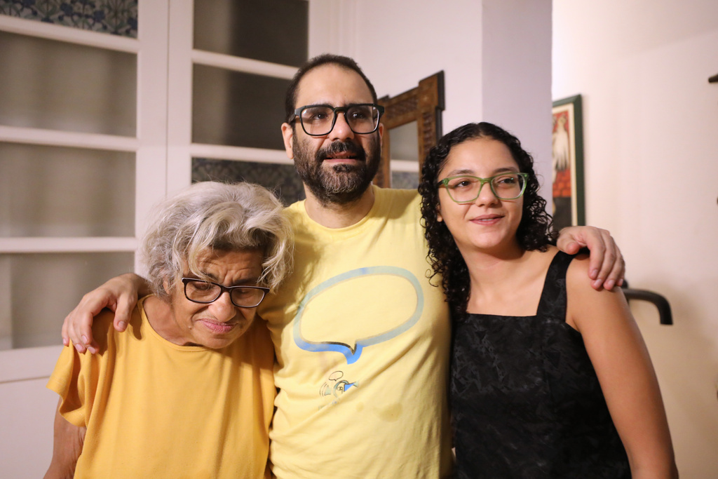 Pro-democracy activist Alaa Abd el-Fattah, who was in prison for almost all of the past 12 years, hugs his mother Laila Soueif and his sister Sanaa Seif at his home after a presidential pardon in Cairo, Tuesday, Sept. 23, 2025. (AP Photo/Khaled Elfiqi)