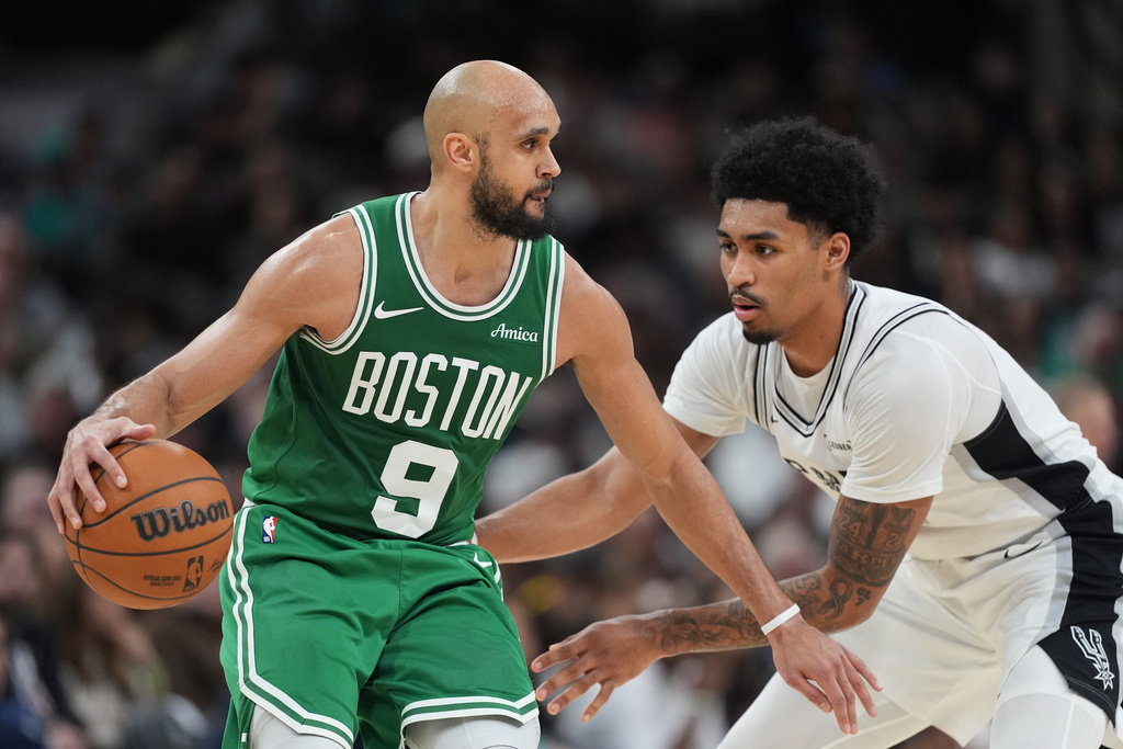 Boston Celtics guard Derrick White (9) works the ball against San Antonio Spurs guard Dylan Harper (2) during the second half of an NBA basketball game in San Antonio, Tuesday, March 10, 2026. (AP Photo/Eric Gay)