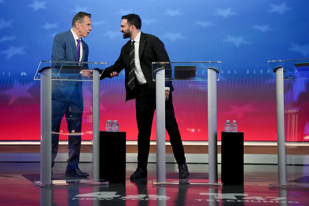 Independent candidate former New York Gov. Andrew Cuomo, left, greets Democratic candidate Zohran Mamdani before participating in a mayoral debate, Thursday, Oct. 16, 2025, in New York. (AP Photo/Angelina Katsanis, Pool)
