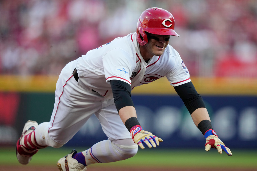 Cincinnati Reds' TJ Friedl dives into third base for a triple to score Jose Trevino during the second inning of a baseball game against the Baltimore Orioles in Cincinnati, Saturday, July 4, 2026. (AP Photo/Carolyn Kaster)