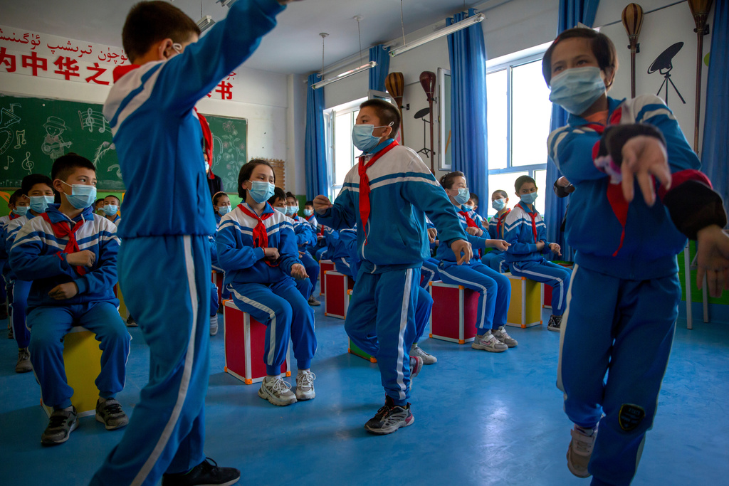FILE - Schoolchildren dance during a music class at a primary school in Awati Township in Kashgar in western China's Xinjiang Uyghur Autonomous Region, as seen during a government organized trip for foreign journalists, April 19, 2021. (AP Photo/Mark Schiefelbein, File)