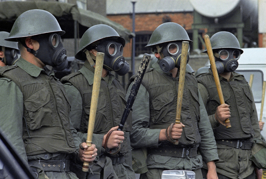 FILE - British Army Riot Squad troops wearing gas masks, bullet proof vests and wielding two foot long batons are seen at a demonstration in Belfast, Northern Ireland on Oct. 2, 1969. (AP Photo/Peter Kemp, File)